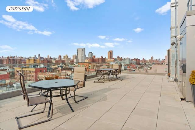 view of patio with visible vents and a city view