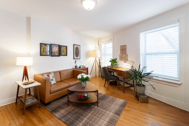 living area featuring baseboards and light wood-style floors