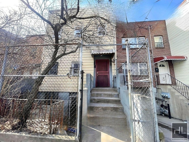 view of front of home with fence and brick siding