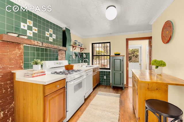 kitchen featuring white appliances, tile walls, ornamental molding, light wood-type flooring, and open shelves