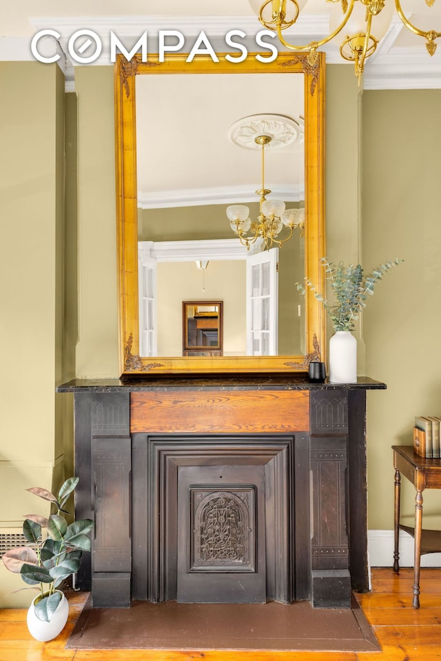 details with wood finished floors and a notable chandelier