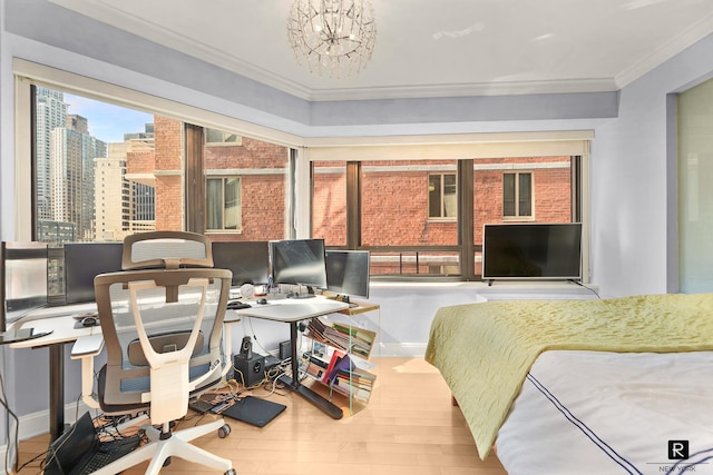 bedroom featuring baseboards, a notable chandelier, ornamental molding, and wood finished floors