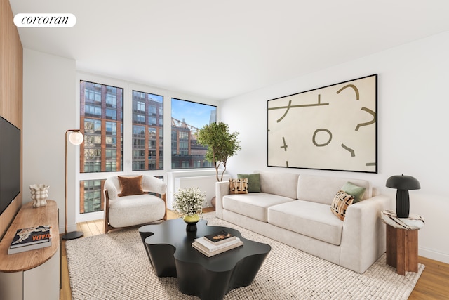415 Main St Unit 10E, New York City, NY 10044 - living room with wood finished floors, a wall of windows, and baseboards