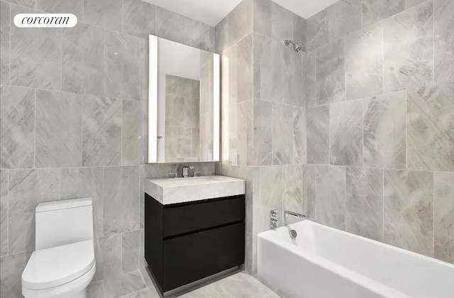 bathroom featuring vanity, toilet, and tile walls