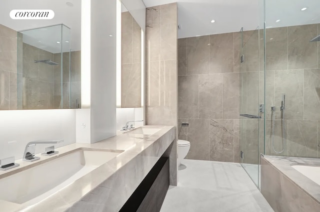 full bathroom with a garden tub, a stall shower, tile walls, and a sink