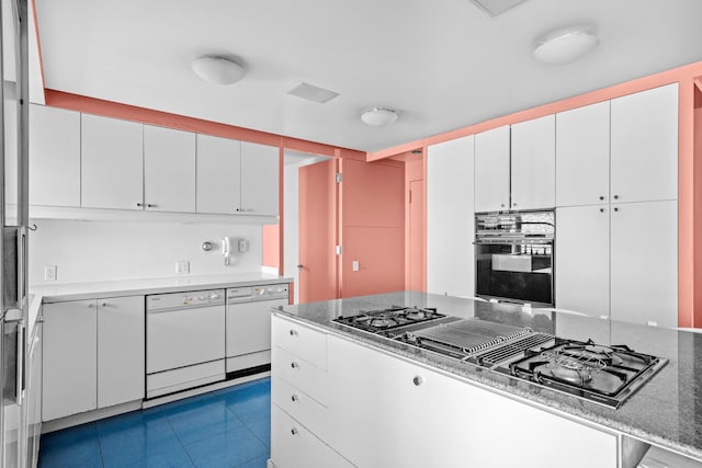 kitchen with stovetop with downdraft, white dishwasher, oven, and white cabinetry