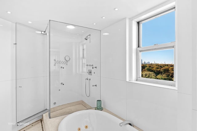 bathroom with a stall shower, a whirlpool tub, and recessed lighting