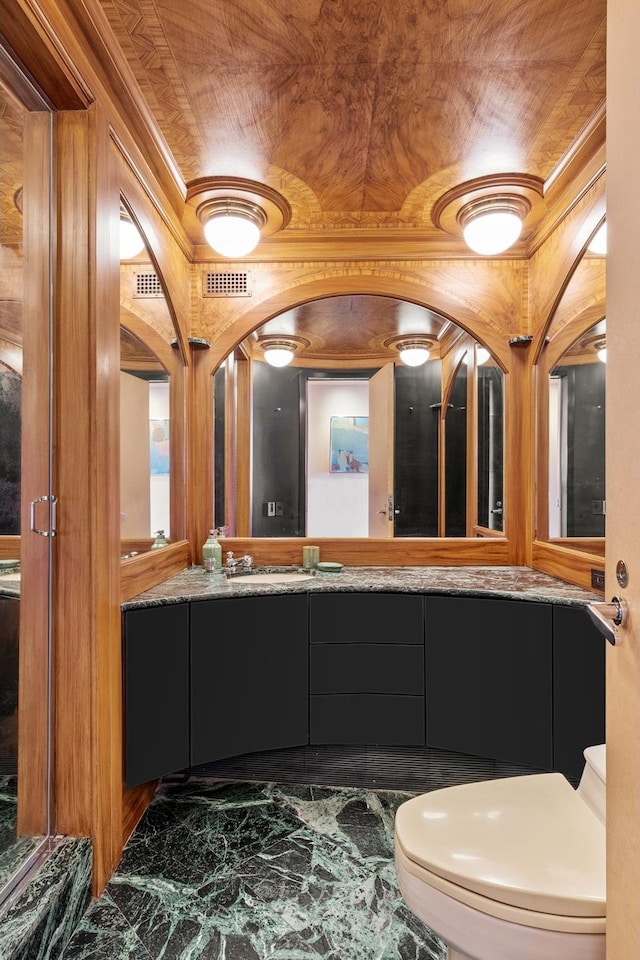 bathroom featuring toilet, marble finish floor, visible vents, and vanity