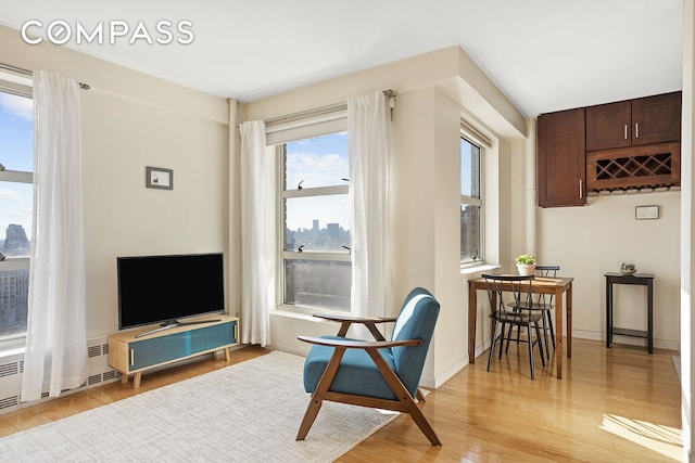 sitting room featuring light wood-style flooring and baseboards