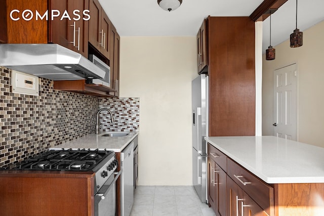 kitchen featuring light tile patterned floors, tasteful backsplash, appliances with stainless steel finishes, a sink, and under cabinet range hood