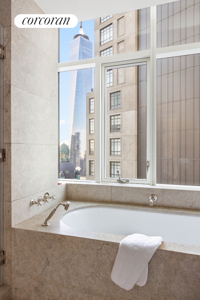 full bath featuring a garden tub and a view of city