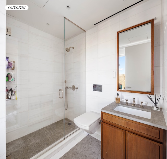 full bath with toilet, a shower stall, tile walls, and vanity