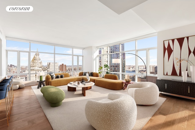 living room featuring a view of city, floor to ceiling windows, visible vents, and wood finished floors