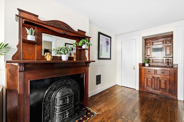 living area featuring visible vents, baseboards, dark wood-style flooring, and a fireplace