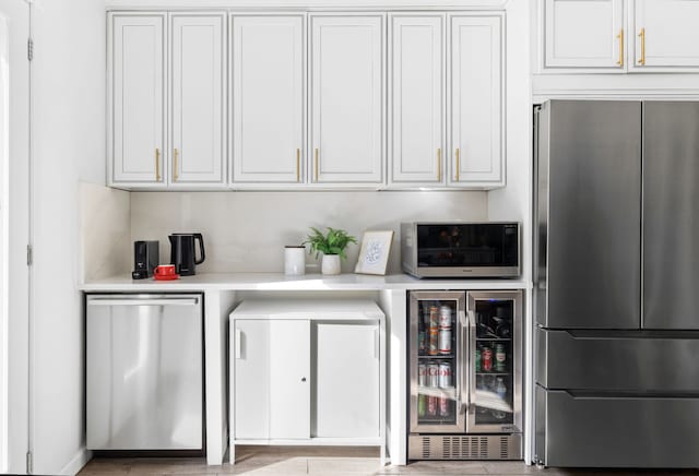 interior space featuring beverage cooler, freestanding refrigerator, and fridge