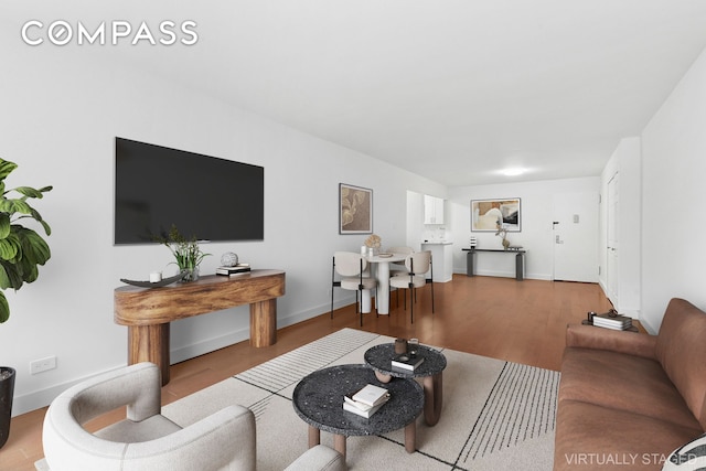333 E 14th St Unit 2C, New York City, NY 10003 - living area featuring wood finished floors and baseboards