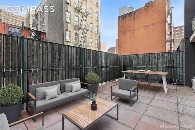 view of patio featuring fence and an outdoor living space