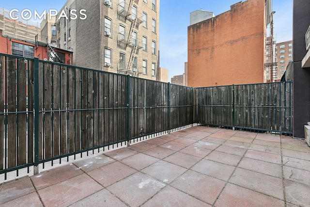 view of patio featuring fence