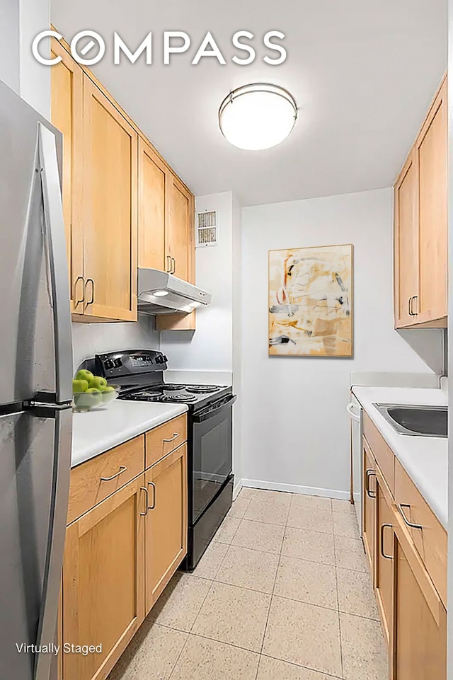 kitchen featuring light countertops, black range with electric stovetop, freestanding refrigerator, a sink, and under cabinet range hood