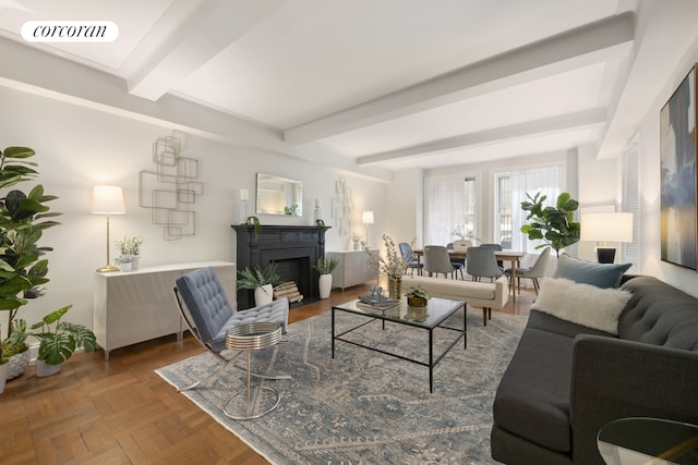 living area with beamed ceiling, a fireplace, and visible vents