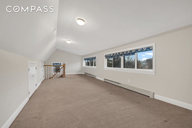 additional living space with vaulted ceiling, baseboards, carpet, and a baseboard radiator