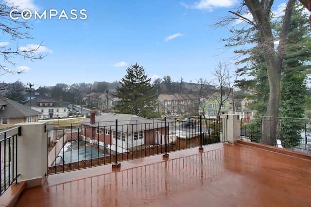 view of patio with a balcony and a residential view