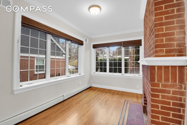 unfurnished sunroom with visible vents and a baseboard heating unit