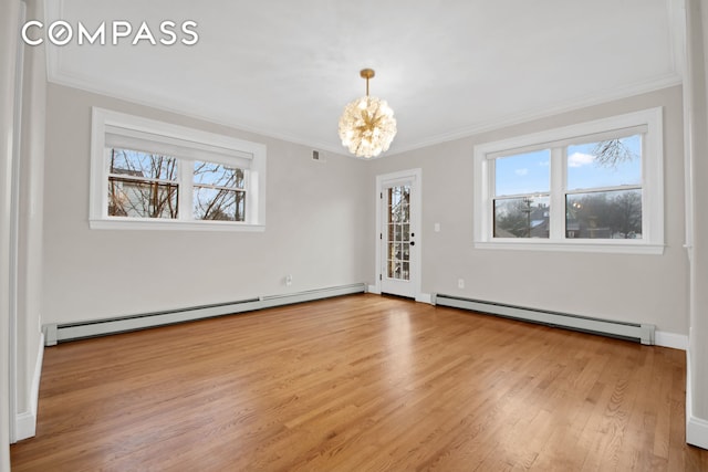 unfurnished room with a baseboard heating unit, crown molding, a notable chandelier, and light wood finished floors