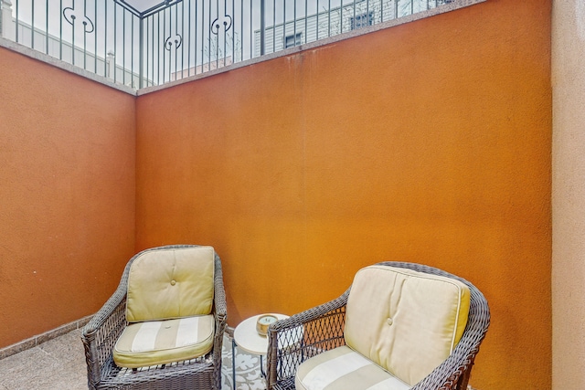 living area with baseboards and carpet floors