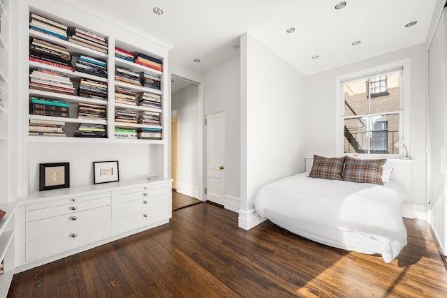 bedroom with baseboards, hardwood / wood-style floors, and recessed lighting