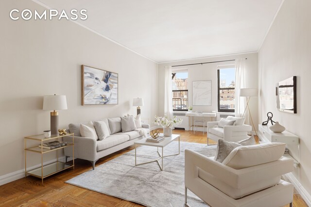 living room featuring crown molding and baseboards