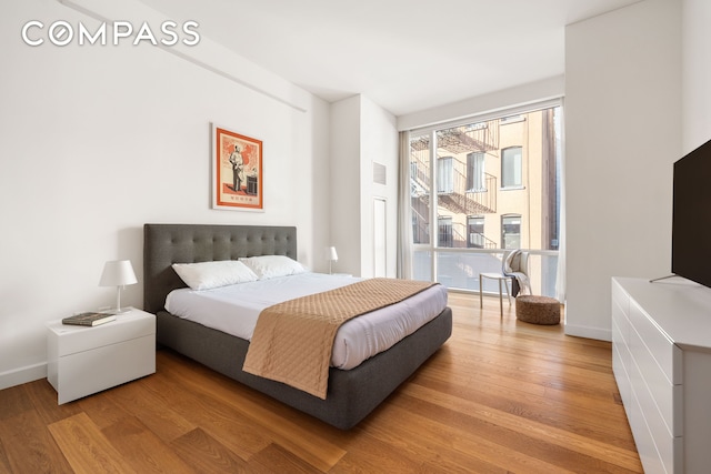 bedroom with light wood-style floors and baseboards