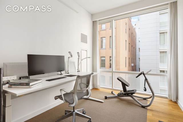 office space featuring light wood-style floors and visible vents