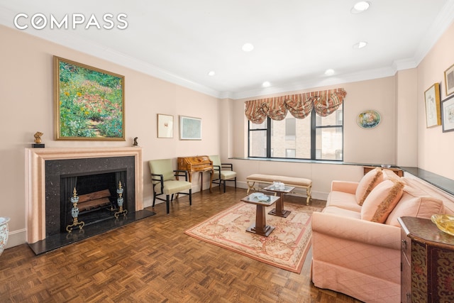 living area with baseboards, recessed lighting, a high end fireplace, and crown molding