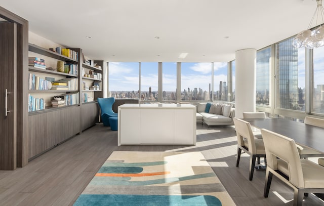 interior space featuring a view of city, floor to ceiling windows, and light wood finished floors