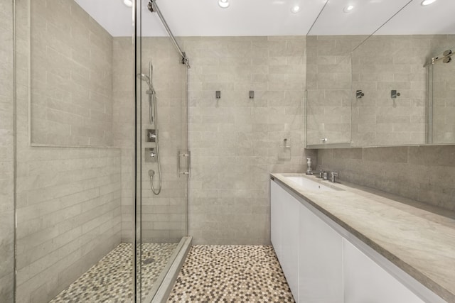 full bath featuring a stall shower, vanity, and recessed lighting