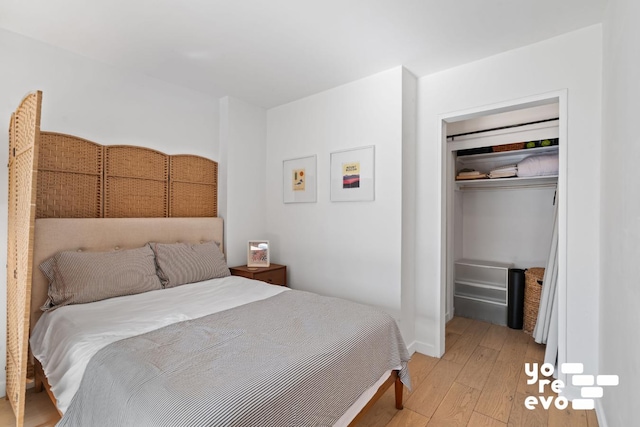 bedroom featuring a closet, light wood-type flooring, and baseboards