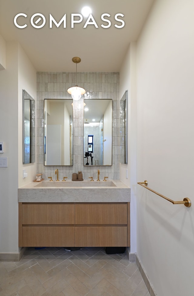 288 W 92nd St Unit 5Ade, New York City, NY 10025 - bathroom with double vanity, baseboards, tile patterned floors, and a shower