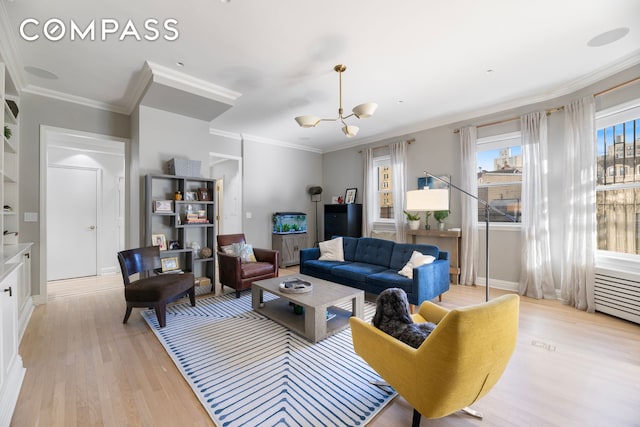 living area featuring crown molding, baseboards, light wood finished floors, and a chandelier