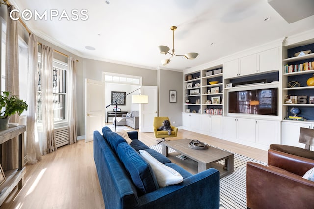 living area with built in shelves, light wood-style flooring, and ornamental molding