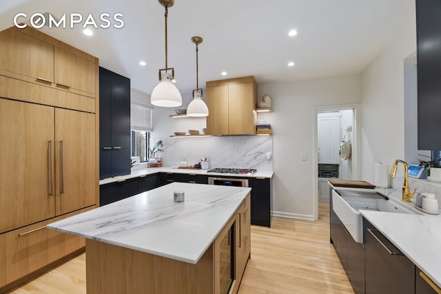 288 W 92nd St Unit 5Ade, New York City, NY 10025 - kitchen with open shelves, light wood-style flooring, a center island, recessed lighting, and a sink