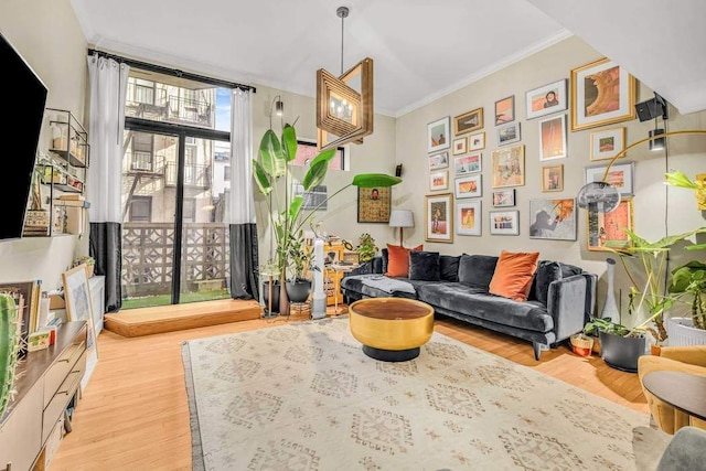 sitting room featuring light wood-style flooring and ornamental molding