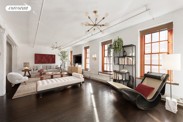 living room with a chandelier, wood finished floors, and visible vents