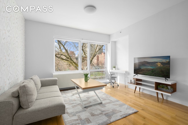 living room with baseboards and wood finished floors