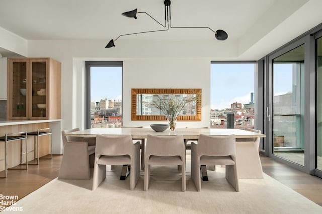 bar with a city view and light wood finished floors