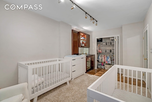 309 E 49th St Unit 2B3B, New York City, NY 10017 - bedroom featuring a closet, wine cooler, track lighting, and light carpet