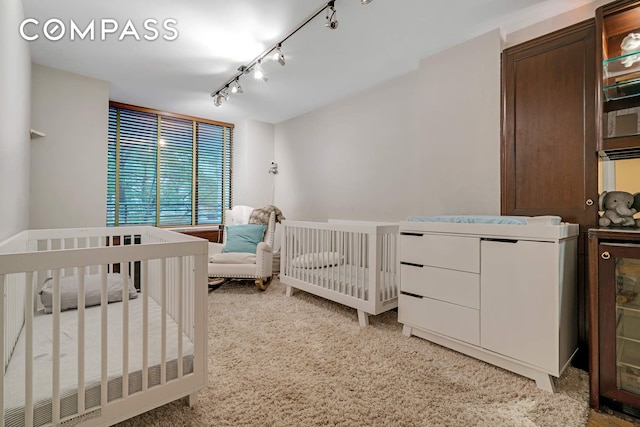 309 E 49th St Unit 2B3B, New York City, NY 10017 - carpeted bedroom featuring rail lighting