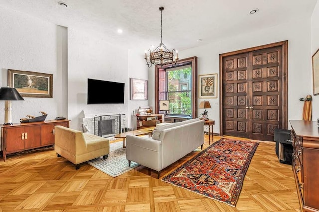 living room with a fireplace, a notable chandelier, and recessed lighting