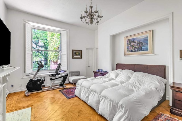 bedroom with an inviting chandelier and baseboards