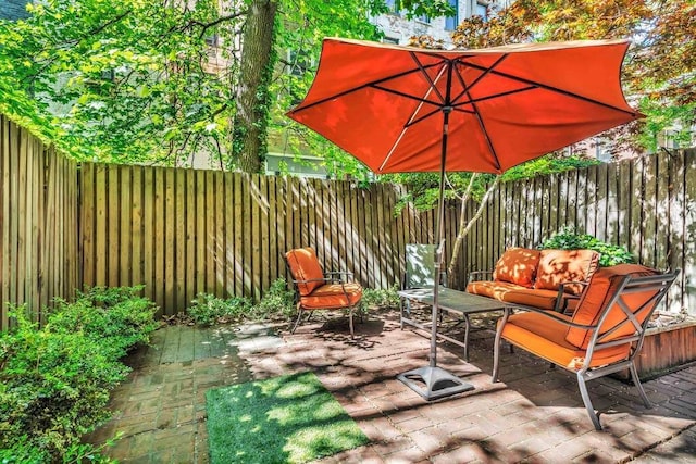 view of patio / terrace featuring a fenced backyard and an outdoor living space